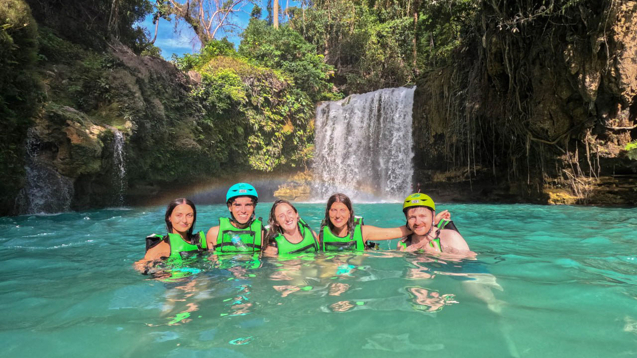 Travelers at a canyon waterfall in Moalboal, Philippines
